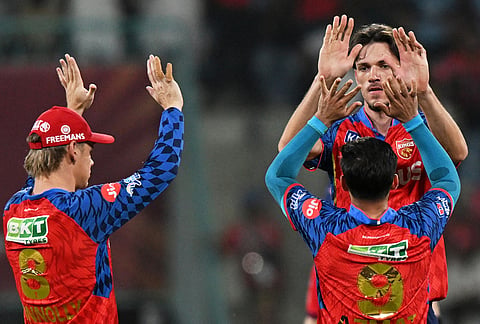 Punjab Kings' Marco Jansen, right, celebrates with teammates the wicket of Lucknow Super Giants' Nicholas Pooran during the Indian Premier League cricket match between Lucknow Super Giants and Punjab Kings, in Lucknow.