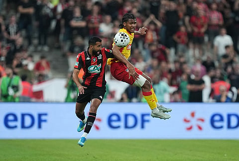 Lens' Kyllian Antonio, right, challenges for the ball with Nice's Ali Abdi, left, during the French Cup soccer final between Nice and Lens in Saint-Denis, outside Paris.