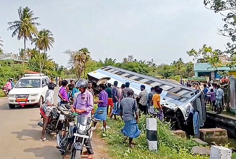People gather after a bus overturns into a canal near Thirukollikadu, in Nagapattinam, Tamil Nadu, Saturday, May 23, 2026. About 10 people were injured. 