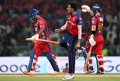 Punjab Kings' Yuzvendra Chahal, centre, celebrates the wicket of Lucknow Super Giants' captain Rishabh Pant, left, during the Indian Premier League cricket match between Lucknow Super Giants and Punjab Kings, in Lucknow.