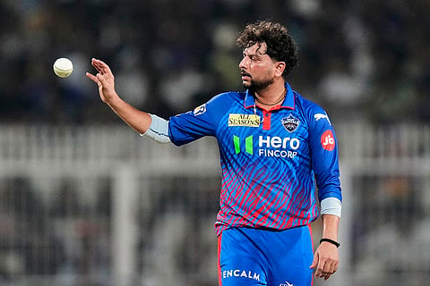 Delhi Capitals' Kuldeep Yadav receives the ball during the Indian Premier League cricket match between Delhi Capitals and Kolkata Knight Riders, in Kolkata, India.
