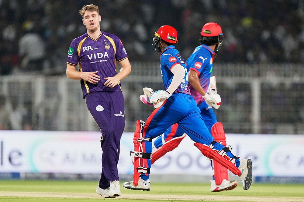 | Photo: AP/Bikas Das : Delhi Capitals Abhishek Porel, centre, and KL Rahul run between the wickets as Kolkata Knight Riders Cameron Green looks on during the Indian Premier League cricket match between Delhi Capitals and Kolkata Knight Riders, in Kolkata, India.