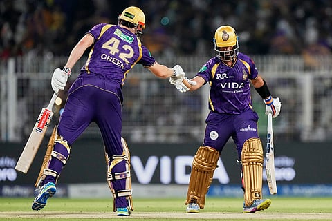 Kolkata Knight Riders' Cameron Green, left, and captain Ajinkya Rahane toss during the Indian Premier League cricket match between Delhi Capitals and Kolkata Knight Riders, in Kolkata, India.