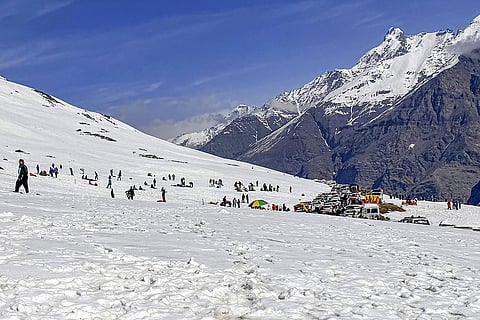 People gather at a snow covered area near Rohtang Pass, in Manali, Himachal Pradesh.