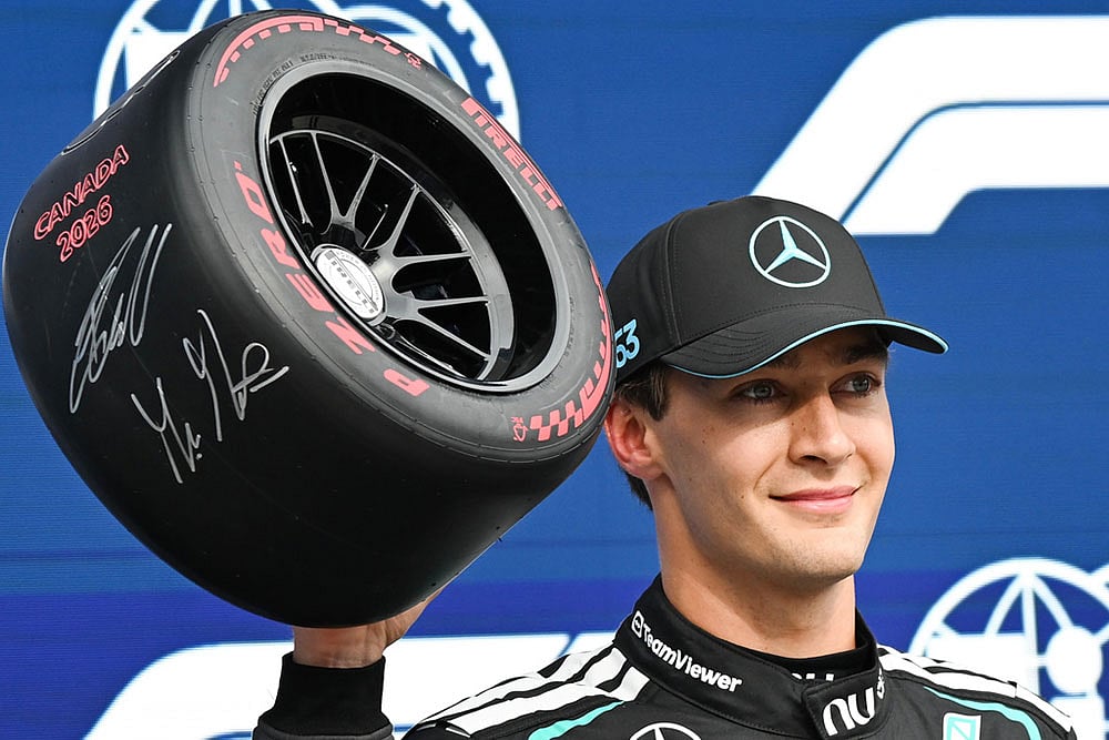 Mercedes driver George Russell, of Britain, celebrates after taking the pole position during qualifying at the F1 Canadian Grand Prix auto race in Montreal. - | Photo: Graham Hughes/The Canadian Press via AP