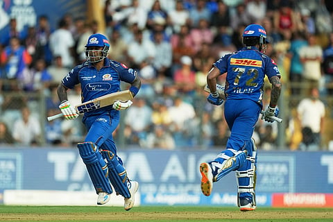 Mumbai Indians' Suryakumar Yadav, left and Tilak Varma run between the wickets during the Indian Premier League cricket match between Mumbai Indians and Rajasthan Royals in Mumbai, India.