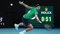 Novak Djokovic Vs Giovanni Mpetshi Perricard Live Score, French Open: Big Serving Perricard Holds Firm At 4-4 | Photo: AP/Aaron Favila : Novak Djokovic of Serbia plays a backhand return to Carlos Alcaraz of Spain during the men's singles final at the Australian Open tennis championship in Melbourne, Australia.
