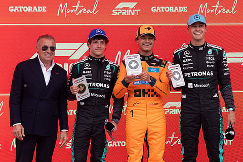 Mercedes driver George Russell, right, of Britain; and first place finisher, poses with from left, Jean Alesi, former Formula One driver, Mercedes driver Kimi Antonelli, of Italy, who placed third, and McLaren driver Lando Norris, of Brtain, who finished in second place following the sprint race at the F1 Canadian Grand Prix auto race in Montreal.