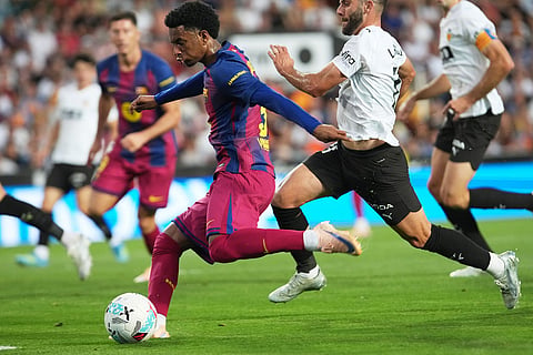 Barcelona's Alejandro Balde attempts a shot on goal during the Spanish La Liga soccer match between Valencia and FC Barcelona in Valencia, Spain.