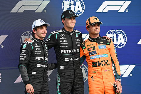 Mercedes driver George Russell, of Britain, center, poses with second place Mercedes driver Kimi Antonelli, left, of Italy, and third place McLaren driver Lando Norris, of Britain, after taking the pole position during qualifying at the F1 Canadian Grand Prix auto race in Montreal.