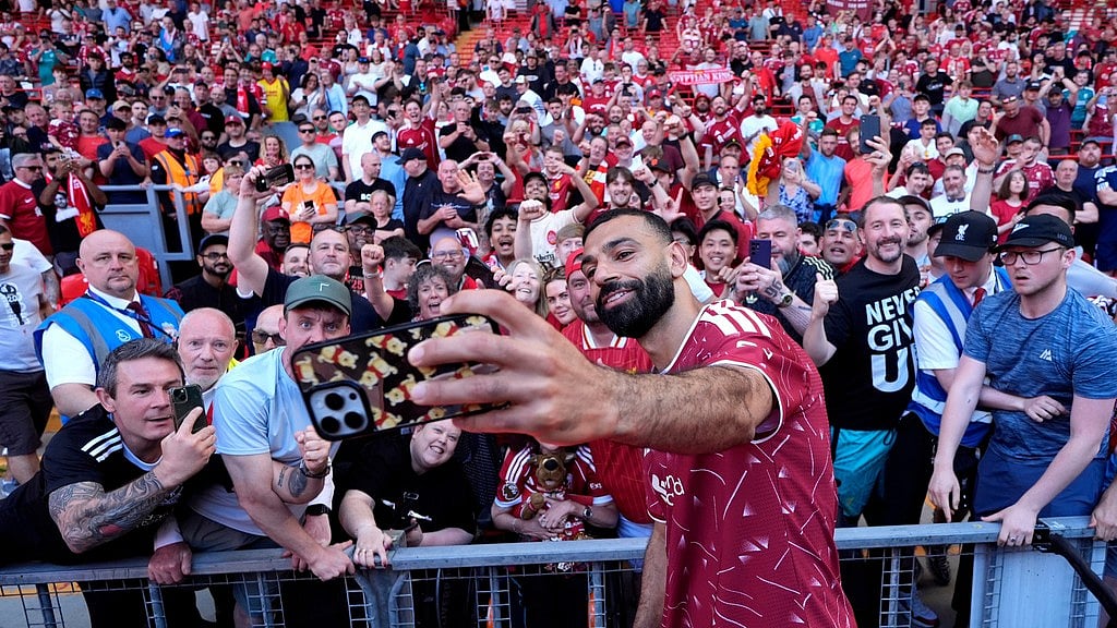 Mohamed Salah takes a selfie with fans following his final Liverpool appearance in the Premier League match at Anfield, Liverpool, England. - Photo: AP/Peter Byrne