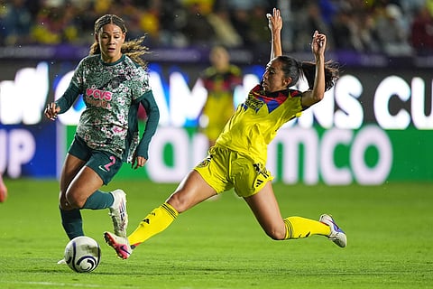 Karina Rodriguez of Mexico's America, right, challenges Trinity Rodman of The United States' Washington Spirit during the Women's CONCACAF Champions Cup final soccer match in Pachuca, Mexico.