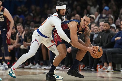 New York Knicks guard Jordan Clarkson, left, defends against Cleveland Cavaliers guard Jaylon Tyson (20) during the first half of Game 3 in the Eastern Conference finals NBA basketball playoffs series in Cleveland.