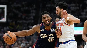 AP/Sue Ogrocki : Cleveland Cavaliers guard Donovan Mitchell (45) controls the ball against New York Knicks guard Landry Shamet (44) during the second half of Game 3 in the Eastern Conference finals NBA basketball playoffs series in Cleveland.