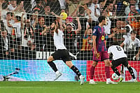 | Photo: AP/Alberto Saiz : Valencia's Luis Rioja, left, celebrates scoring his side's 2nd goal during the Spanish La Liga soccer match between Valencia and FC Barcelona in Valencia, Spain.