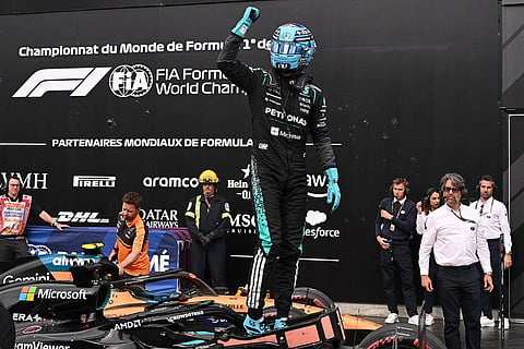 Mercedes driver George Russell, of Britain, celebrates as he takes the pole position following qualifying at the F1 Canadian Grand Prix auto race in Montreal.