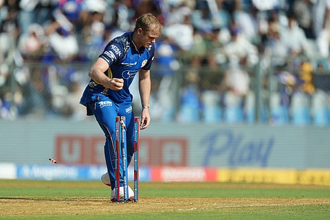 Mumbai Indians' Corbin Bosch takes the bails off to run Rajasthan Royals' Dasun Shanaka out during the Indian Premier League cricket match between Mumbai Indians and Rajasthan Royals in Mumbai, India.
