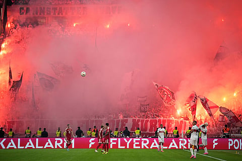 Soccer fans burn flares and hold flags during the DFB Pokal, German Cup final soccer match between VfB Stuttgart and Bayern Munich in Berlin, Germany.