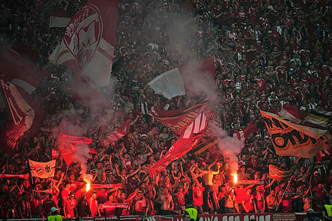 Bayern Munich supporters burn flares and hold flags during the DFB Pokal, German Cup final soccer match between VfB Stuttgart and Bayern Munich in Berlin, Germany.
