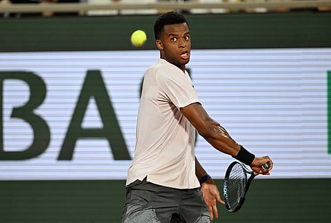 Giovanni Mpetshi Perricard of France returns to Novak Djokovic of Serbia during their first round men's singles tennis match at the French Open tennis tournament in Paris.