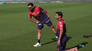 PTI : Royal Challengers Bengaluru's Virat Kohli, left, and Bhuvneshwar Kumar during a practice session ahead of the Indian Premier League Qualifier 1 match against Gujarat Titans, in Dharamsala, Himachal Pradesh.