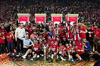 | Photo: AP/Thanassis Stavrakis : Olympiacos' team pose for a photo after winning the Euroleague final basketball match against Real Madrid in Athens, Greece.