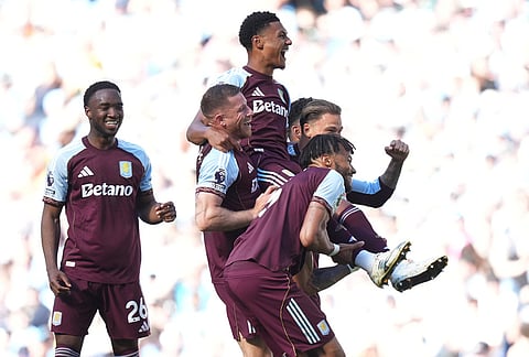 Team mates carry Aston Villa's Ollie Watkins after he scored during a Premier League soccer match between Manchester City and Aston Villa in Manchester, England.
