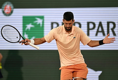 Novak Djokovic of Serbia celebrates after winning the first round men's singles tennis match against against Giovanni Mpetshi Perricard of France at the French Open tennis tournament in Paris.