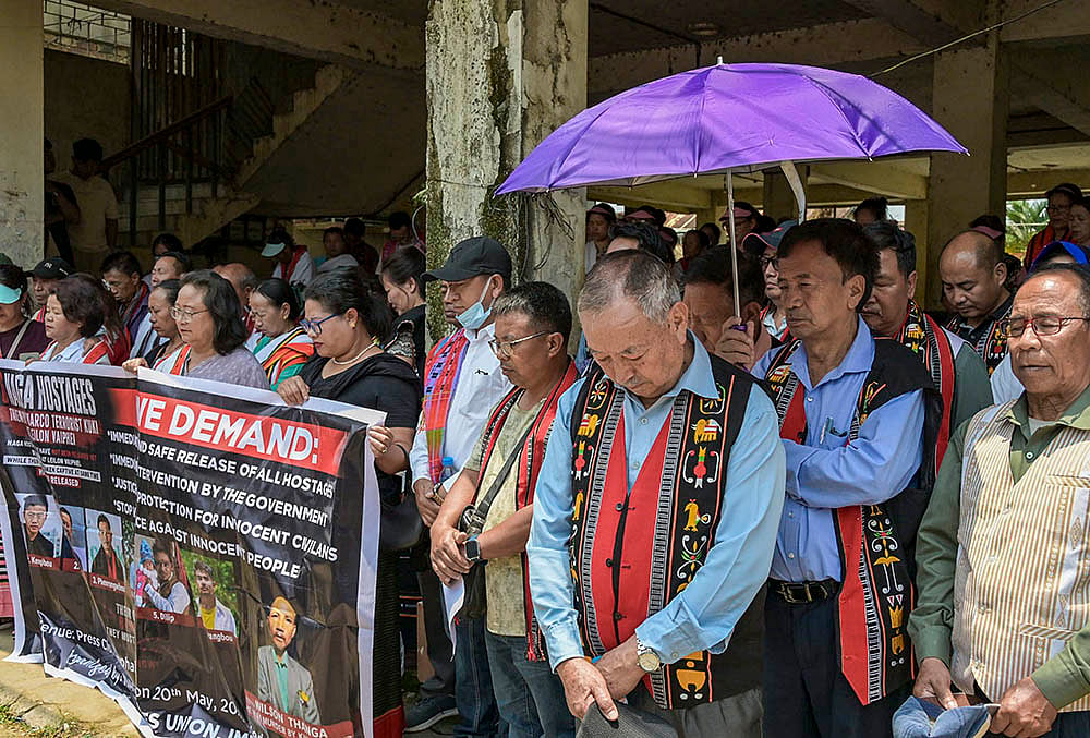 People hold a banner and participate in a protest rally demanding the immediate release of six civilians allegedly held hostage by suspected Kuki militants, in Imphal, Manipur. More than 38 people were abducted and held hostage by armed groups in Kangpokpi and Senapati districts on May 13, hours after three church leaders were killed in an ambush in Kangpokpi district. - | Photo: PTI