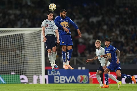 Cruz Azul's Amaury Garcia, left, and Pumas' Juninho during the Mexican soccer league second leg final match in Mexico City.