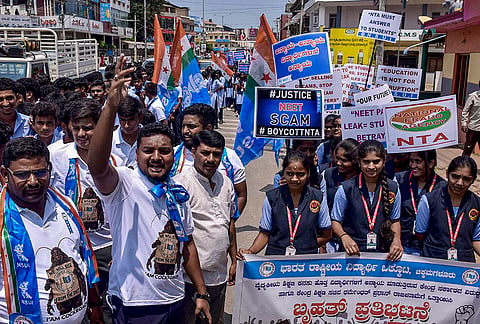 NSUI activists along with school students take out a protest rally against the alleged NEET scam and the Union government, in Chikkamagaluru, Karnataka.