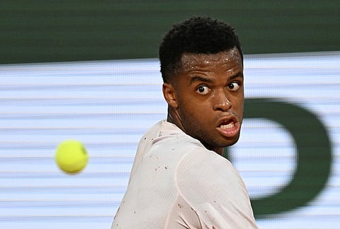Giovanni Mpetshi Perricard of France returns to Novak Djokovic of Serbia during their first round men's singles tennis match at the French Open tennis tournament in Paris.