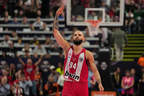 Olympiacos' Evan Fournier celebrates after making a 3-point shot during the Euroleague final basketball match between Olympiacos and Real Madrid in Athens, Greece.