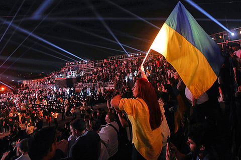 Oleksandr Usyk fans celebrate after he won his boxing match against Rico Verhoeven during the WBC World Heavyweight Championship "Glory in Giza" at the site of the Pyramids of Giza, in Giza, Egypt.