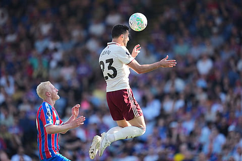 Arsenal's Mikel Merino heads the ball ahead of Crystal Palace's Will Hughes during the English Premier League soccer match between Crystal Palace and Arsenal in London, England.