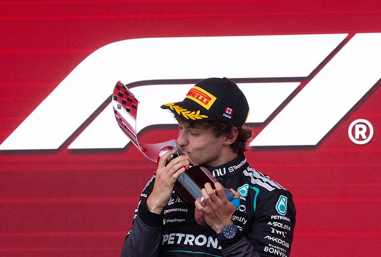 Mercedes driver Kimi Antonelli, of Italy, kisses his trophy following his win in the F1 Canadian Grand Prix auto race in Montreal. - | Photo: Christinne Muschi/The Canadian Press via AP