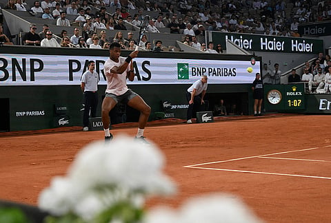 Giovanni Mpetshi Perricard of France returns to Novak Djokovic of Serbia during their first round men's singles tennis match at the French Open tennis tournament in Paris.