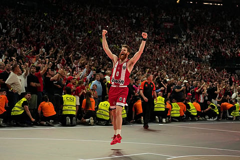 Olympiacos' Thomas Walkup celebrates after winning the Euroleague final basketball match against Real Madrid in Athens, Greece.