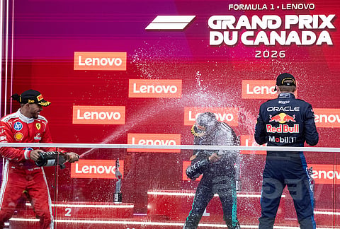 Winner Mercedes driver Kimi Antonelli, center, of Italy, is sprayed by second-place Ferrari driver Lewis Hamilton, left, of Britain, and third-place Red Bull Racing driver Max Verstappen, right, of the Netherlands, after the F1 Canadian Grand Prix auto race in Montreal.