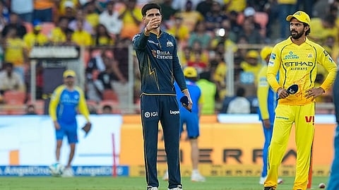 Gujarat Titans' captain Shubman Gill flips the coin as Chennai Super Kings' captain Ruturaj Gaikwad, right, looks on during the toss ahead of the Indian Premier League (IPL) 2026 T20 cricket match between Gujarat Titans and Chennai Super Kings, in Ahmedabad, Gujarat.