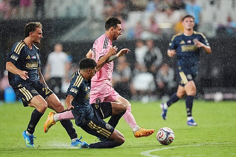 Inter Miami forward Lionel Messi, center, drives forward under pressure from Philadelphia Union forward Augustin Anello, left, and defender Nathan Harriel, bottom, during the second half of an MLS soccer match in Miami.