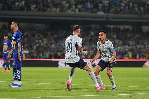 Cruz Azul's Rodolfo Rotondi, left, and Carlos Rodriguez celebrate after Pumas' Ruben Duarte scored an own goal during the Mexican soccer league second leg final match in Mexico City.