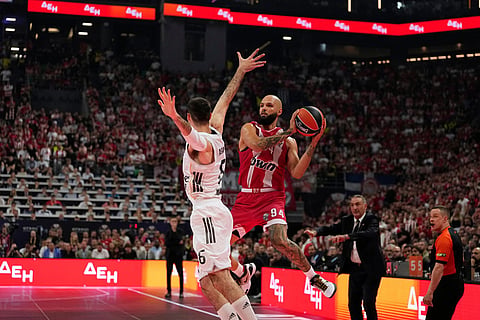 Olympiacos' Evan Fournier drives to the basket against Real Madrid's Alberto Abalde during the Euroleague final basketball match between Olympiacos and Real Madrid in Athens, Greece.
