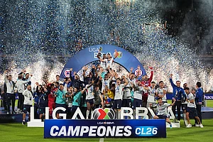 | Photo: AP/Eduardo Verdugo : Cruz Azul players celebrate with the trophy after winning the Mexican soccer league final against Pumas in Mexico City.
