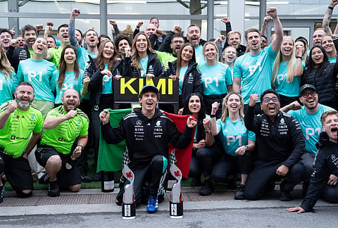 Mercedes driver Kimi Antonelli, center front, of Italy, celebrates after his win with his team following the F1 Canadian Grand Prix auto race in Montreal.