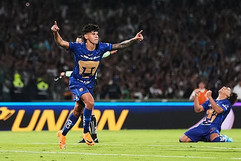 Pumas' Robert Morales, left, celebrates scoring his side's opening goal against Cruz Azul during the Mexican soccer league second leg final match in Mexico City.