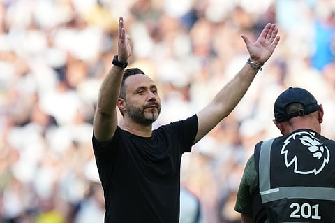 Tottenham's head coach Roberto De Zerbi greets fans after the English Premier League soccer match between Tottenham Hotspur and Everton in London, England.