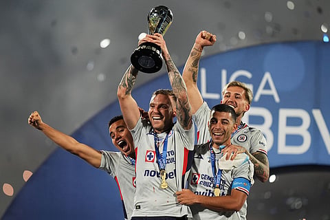 Cruz Azul' players celebrate with the trophy after winning the Mexican soccer league final against Pumas in Mexico City.