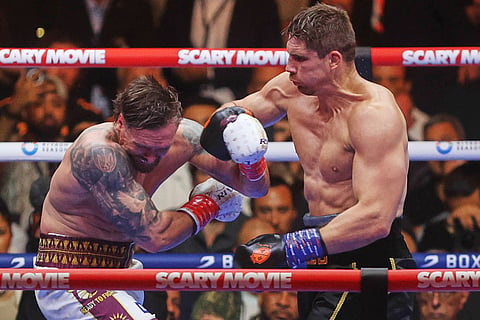 Oleksandr Usyk, left, fights during a boxing match against Rico Verhoeven, right, at the WBC World Heavyweight Championship "Glory in Giza" at the site of the Pyramids of Giza, in Giza, Egypt.