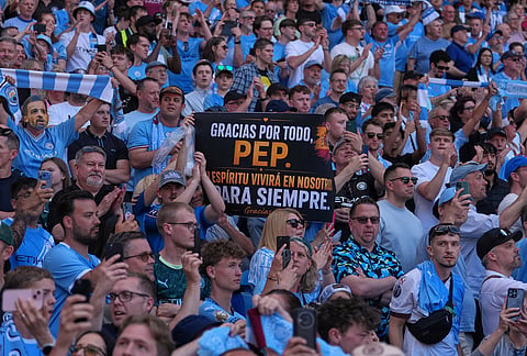 Manchester City fans holds a sign thanking the coach Pep Guardiola during his last macth as a manager during a Premier League soccer match between Manchester City and Aston Villa in Manchester, England.